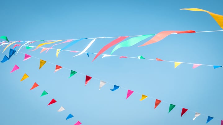 Fair flag blur bunting background hanging on blue sky for fun festa party event, summer holiday farm feast celebration, carnival festival event, park or street design decoration element